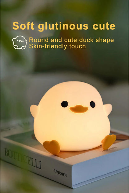 Doudou Duck Night Lamp on a book 