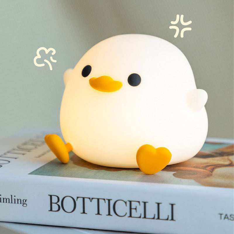 Doudou Duck Night Lamp on a book 